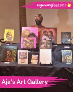 Aja's Art Gallery - IngenuityFest Vendor 2026 - Artist behind table displaying original painted art and prints.