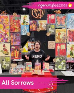 All Sorrows - IngenuityFest Vendor 2026 - Vendor making scary face behind table displaying horror prints and comics.