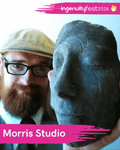 Morris Studio - IngenuityFest Vendor - Bearded Man with beret and glasses next to sculpture of a face.