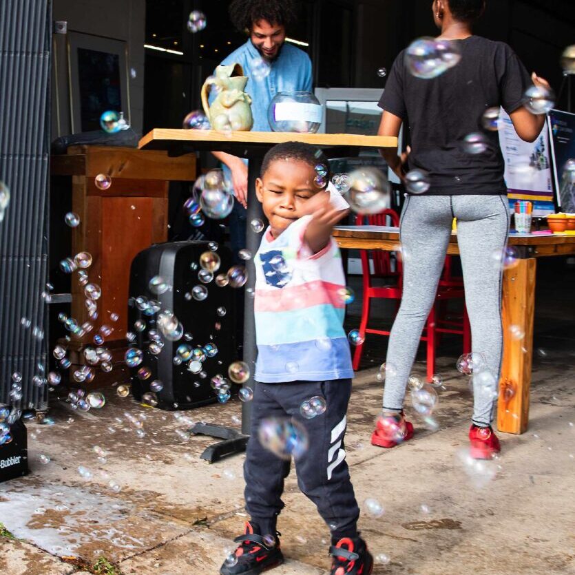 Ignite Neighbor Nights Kid Playing with Bubbles